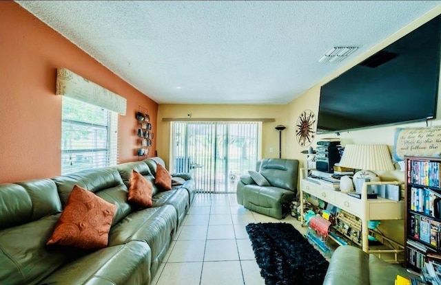 tiled living room featuring a textured ceiling