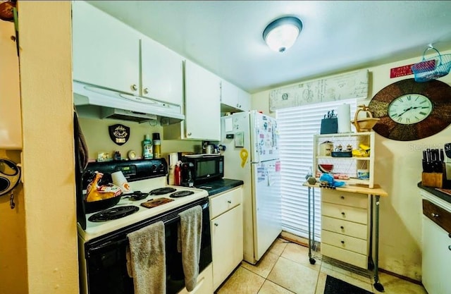 kitchen with light tile patterned floors, white appliances, and white cabinets