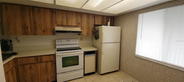 kitchen with white appliances and light tile patterned floors