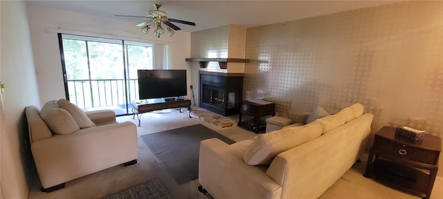 living room featuring ceiling fan, carpet floors, and a multi sided fireplace