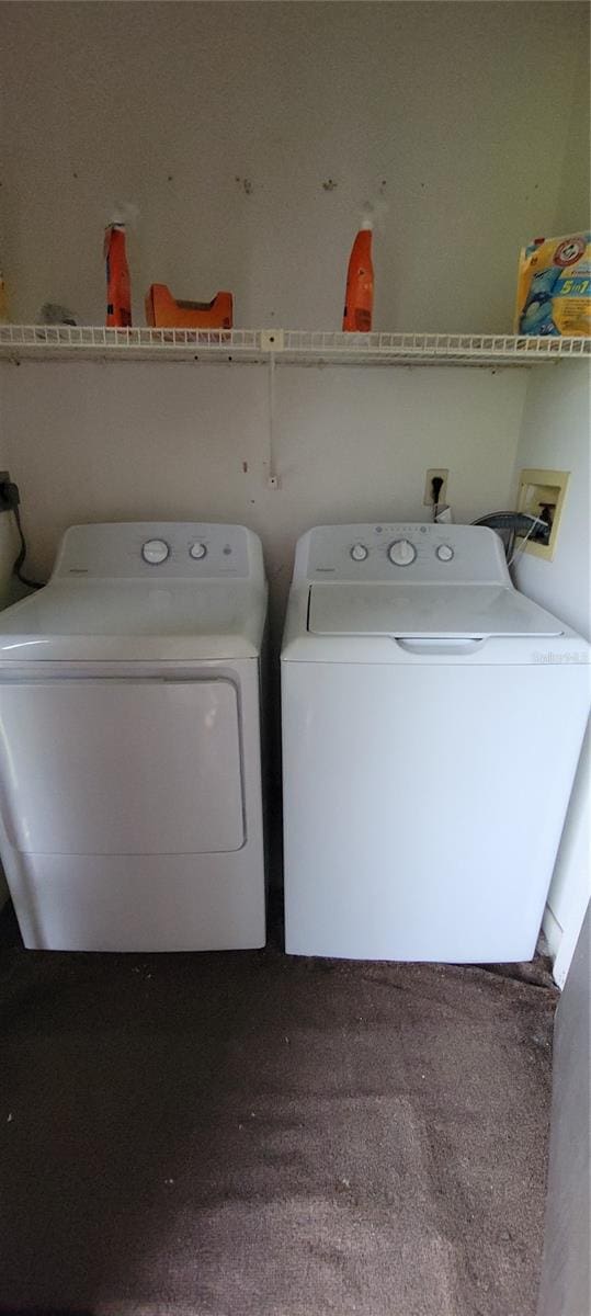 clothes washing area featuring carpet floors and separate washer and dryer