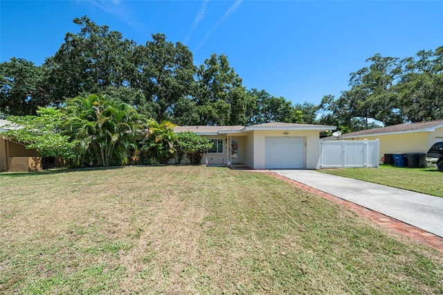 single story home featuring fence, driveway, stucco siding, a front lawn, and a garage