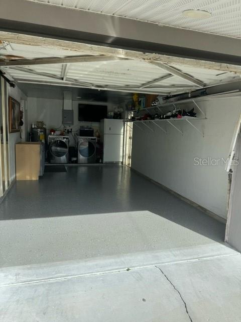 garage with white refrigerator and washing machine and dryer