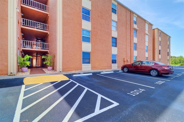 view of property featuring uncovered parking