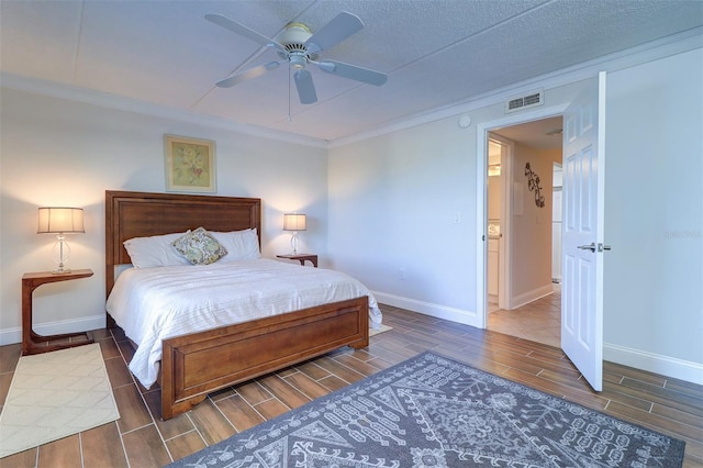 bedroom with baseboards, visible vents, wood tiled floor, ceiling fan, and crown molding