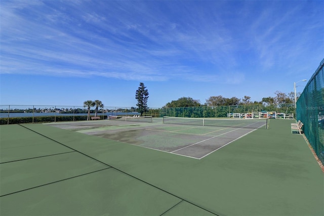 view of tennis court featuring fence