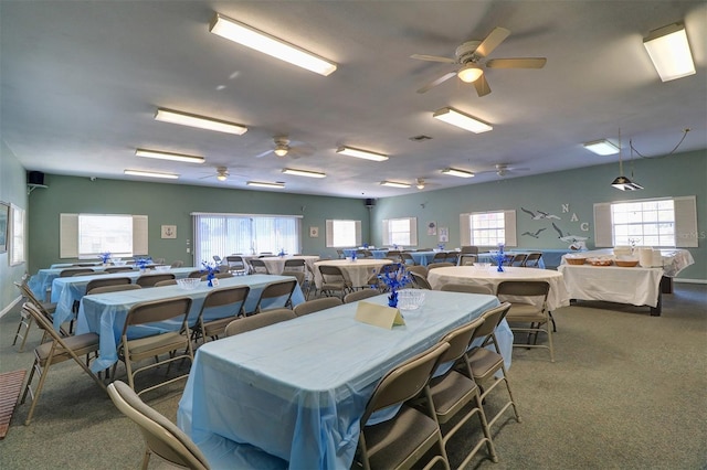 dining room with dark carpet and ceiling fan