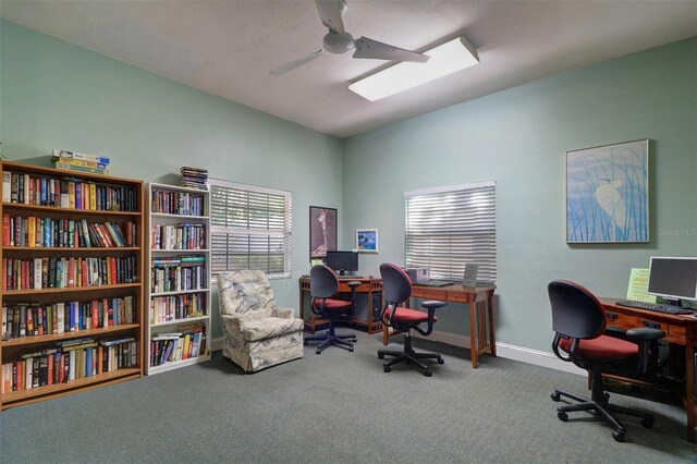 carpeted home office featuring ceiling fan