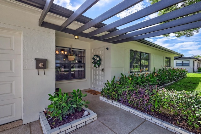 entrance to property featuring a pergola