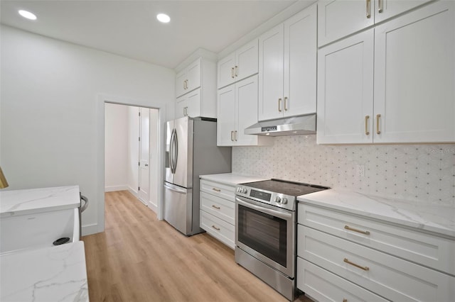 kitchen featuring light hardwood / wood-style flooring, light stone counters, appliances with stainless steel finishes, and white cabinetry