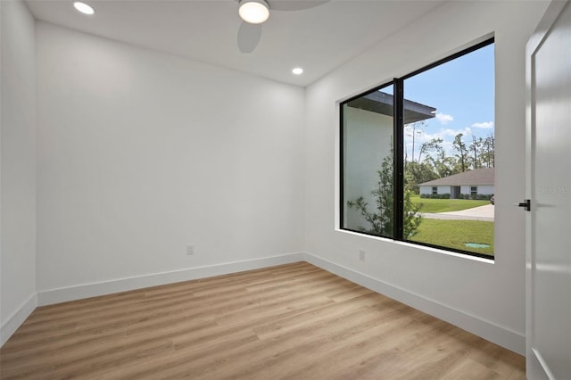 unfurnished room with ceiling fan and light wood-type flooring