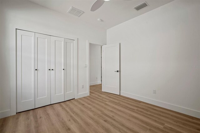 unfurnished bedroom featuring a closet, ceiling fan, and light hardwood / wood-style flooring