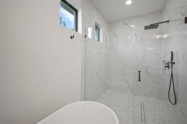 bathroom featuring separate shower and tub