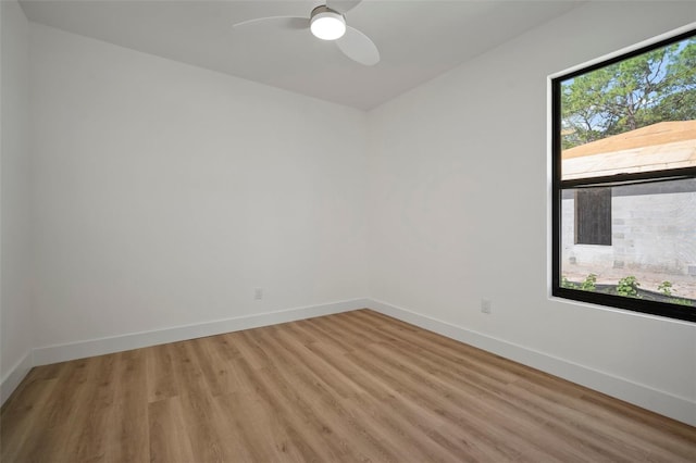 spare room featuring ceiling fan and hardwood / wood-style flooring