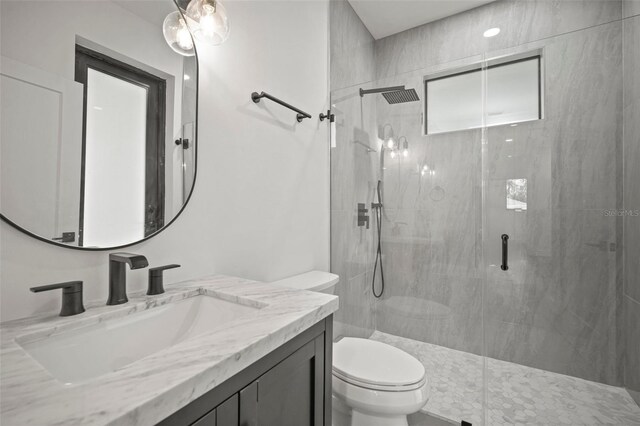 bathroom with vanity, toilet, and an enclosed shower