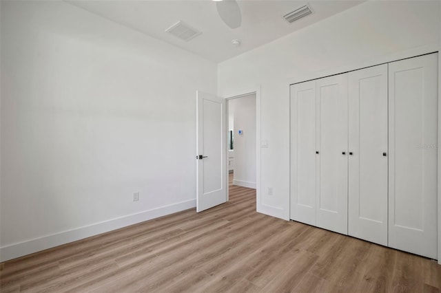 unfurnished bedroom featuring a closet, ceiling fan, and light hardwood / wood-style flooring