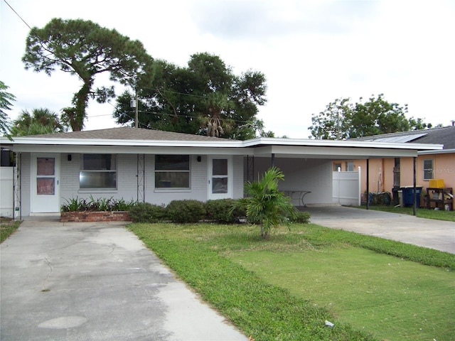 ranch-style home featuring a front yard and a carport