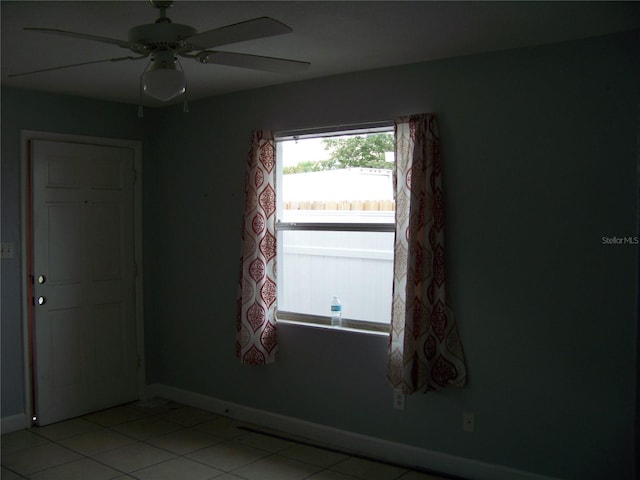 unfurnished room featuring ceiling fan and light tile patterned floors