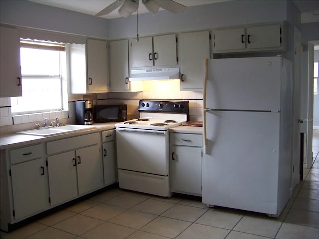 kitchen featuring white appliances, sink, decorative backsplash, white cabinetry, and ceiling fan