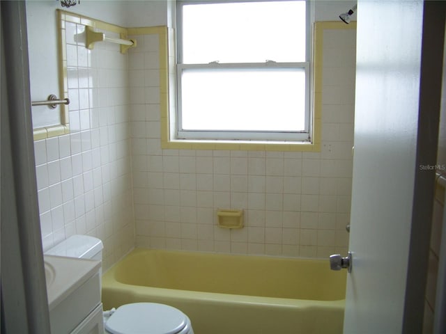 full bathroom featuring vanity, toilet, and tiled shower / bath combo