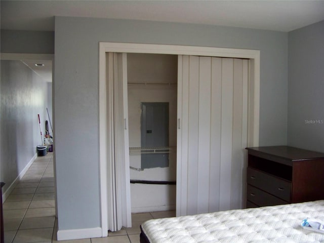 bedroom with a closet and light tile patterned floors