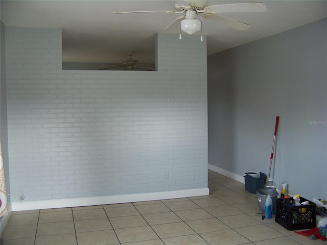 tiled spare room with ceiling fan