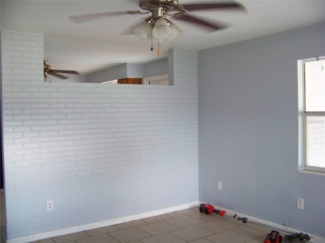 tiled spare room featuring ceiling fan