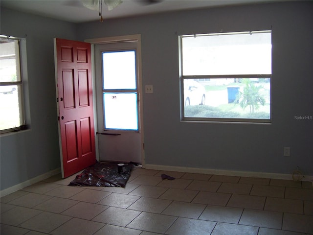 tiled entrance foyer featuring plenty of natural light and ceiling fan