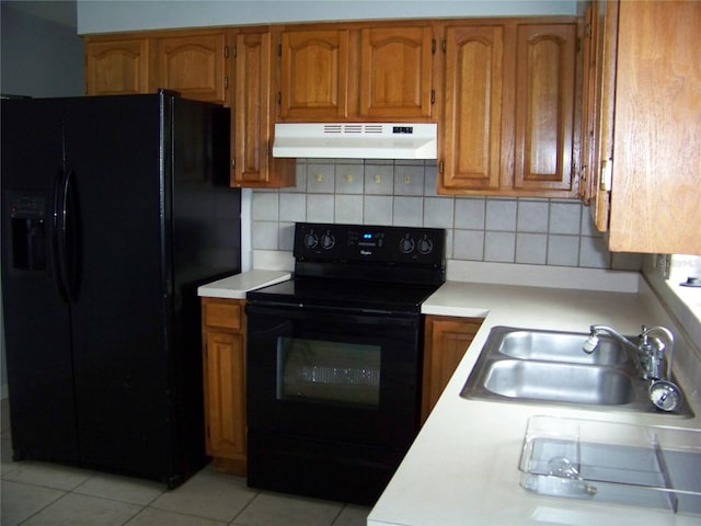 kitchen featuring black appliances, light tile patterned floors, decorative backsplash, and sink