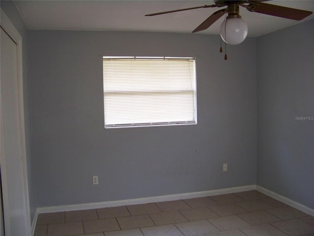 tiled empty room with ceiling fan