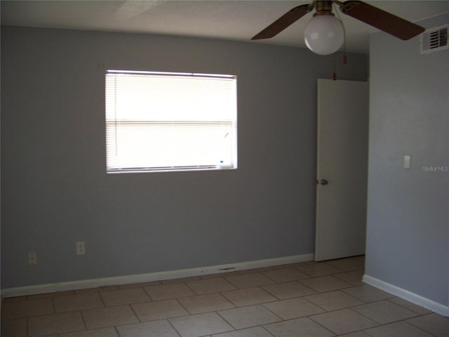 spare room with light tile patterned flooring and ceiling fan