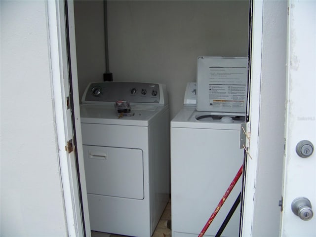 clothes washing area with washing machine and dryer