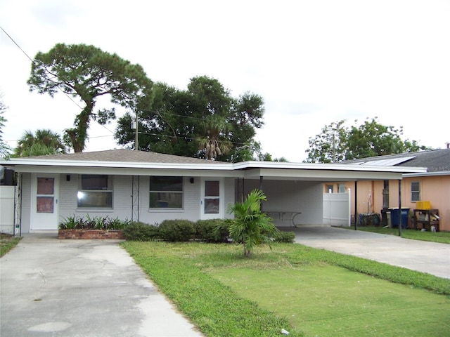 ranch-style house with a front yard and a carport