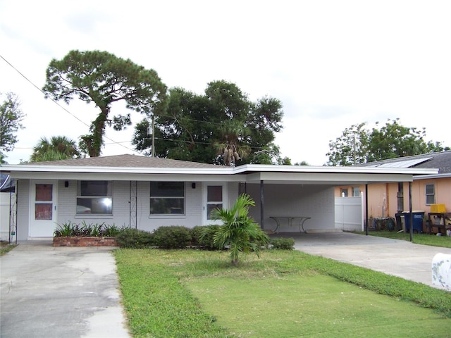 ranch-style house featuring a carport and a front lawn