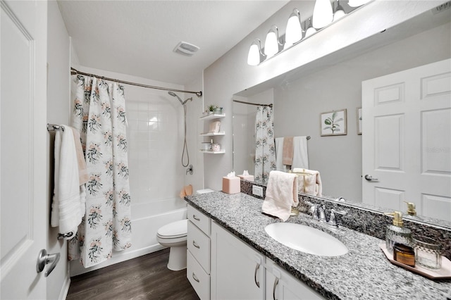 full bathroom with hardwood / wood-style floors, shower / bath combination with curtain, toilet, and vanity