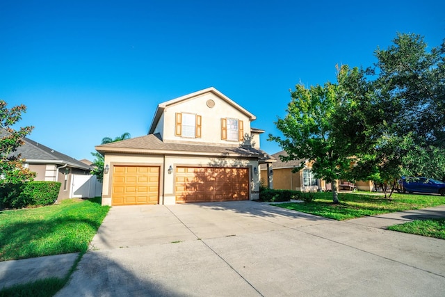 view of front of home with a garage and a front lawn