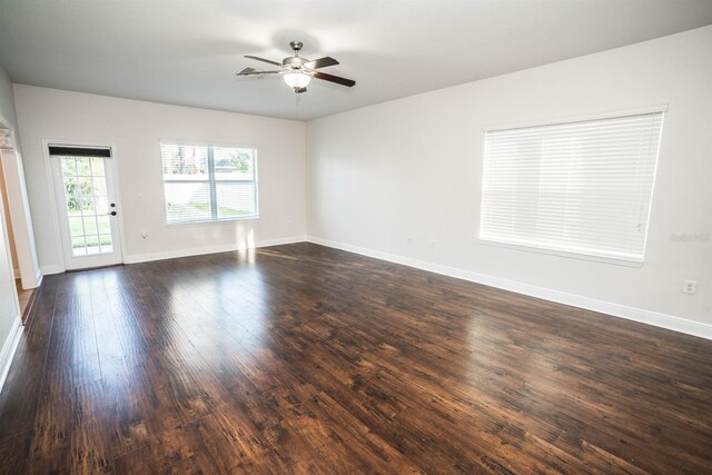 unfurnished room with dark wood-type flooring and ceiling fan