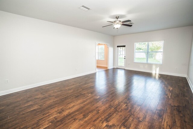 spare room with ceiling fan and dark hardwood / wood-style floors