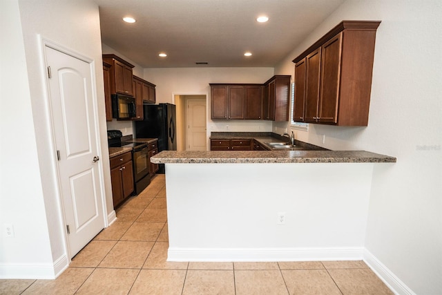 kitchen with black appliances, light tile patterned flooring, kitchen peninsula, and sink