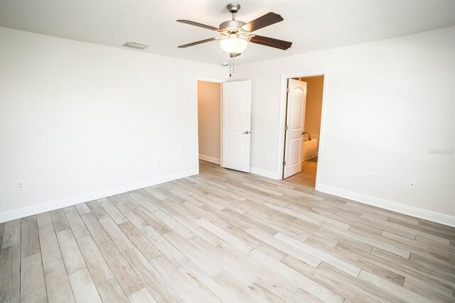 spare room with ceiling fan and light hardwood / wood-style floors