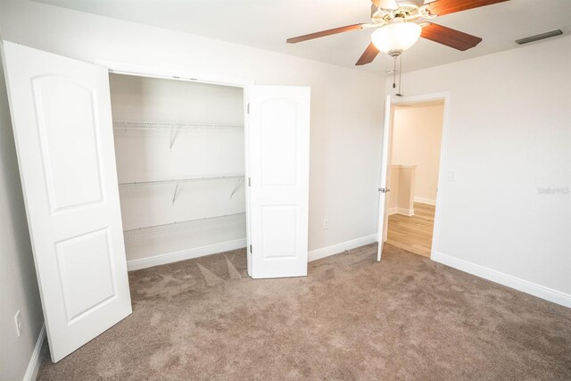 unfurnished bedroom with carpet flooring, a closet, and ceiling fan