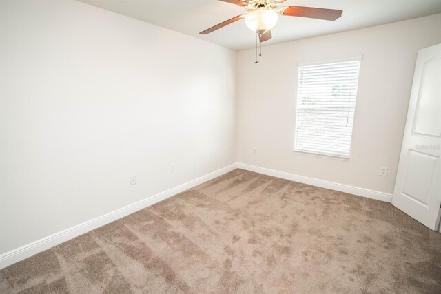 empty room with ceiling fan and carpet flooring