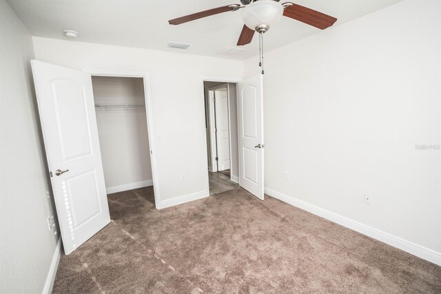 unfurnished bedroom with carpet floors, ceiling fan, and a closet