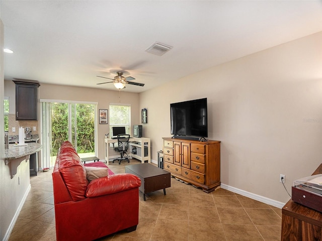 tiled living room featuring ceiling fan