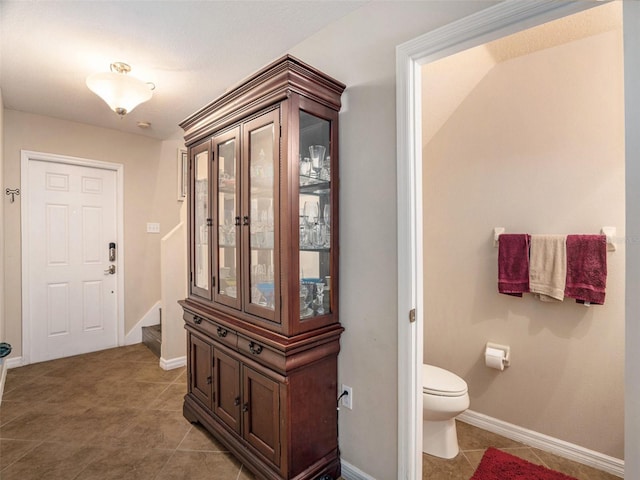 bathroom with toilet and tile patterned flooring