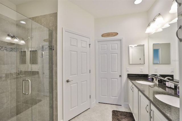 bathroom with a shower with door and vanity