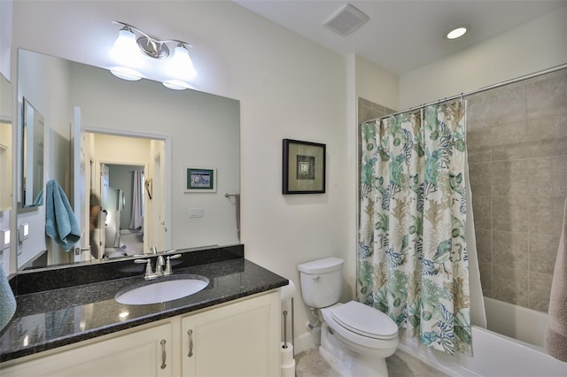 full bathroom with vanity, shower / tub combo, and toilet