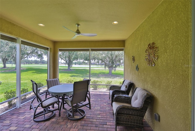 sunroom featuring ceiling fan