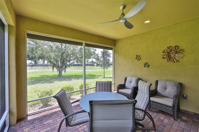 sunroom featuring plenty of natural light and ceiling fan