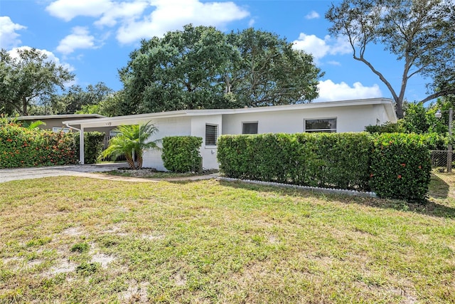 ranch-style home featuring a front yard